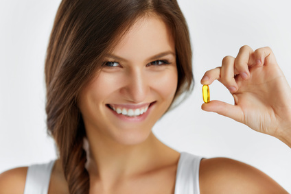 Nutrition. Healthy Lifestyle. Woman Holding Pill With Fish Oil Omega-3. Supplements, Vitamins.